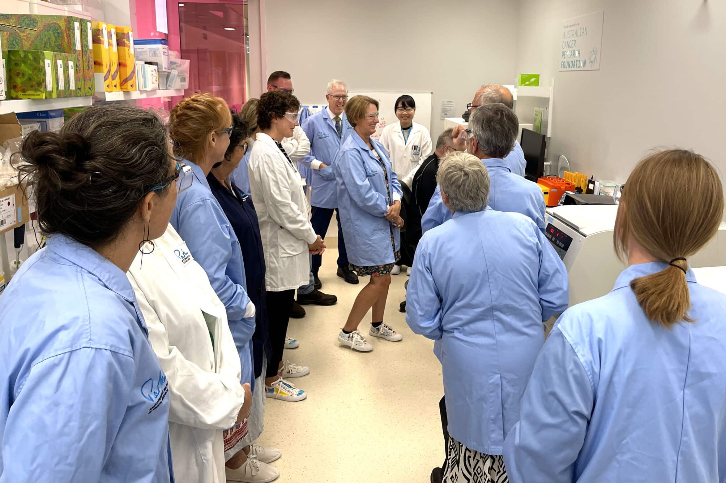 people in lab coats inside a cancer laboratory
