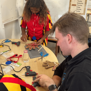 Perkins trainer assists young remote Indigenous student with robot making